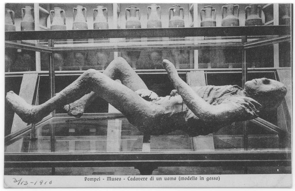 Victim 9, with fig leaf applied to the cast’s body, photographed in display case in museum, c.1900. 
Part of the metal stick found with the victim is exhibited on the right side of the cast. Photo courtesy of Eugene Dwyer.
