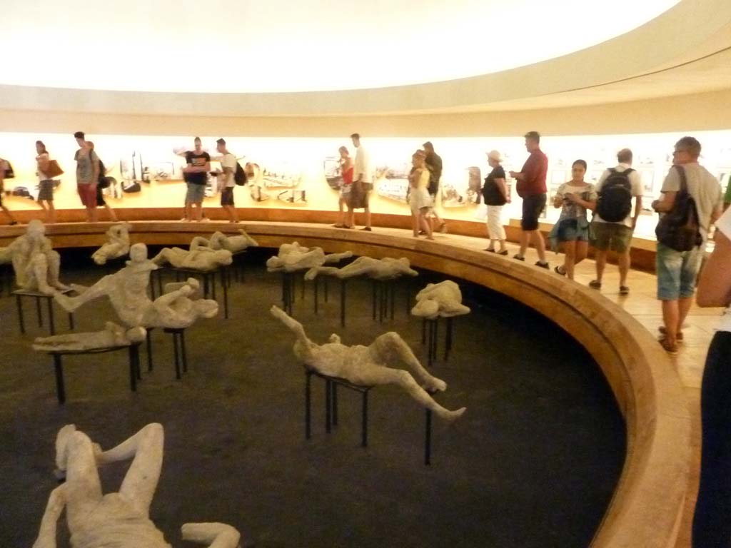 Victim 79. Cast of the running man from the Palaestra? September 2015. Cast (in centre) viewed from right side. On exhibition in the amphitheatre.
