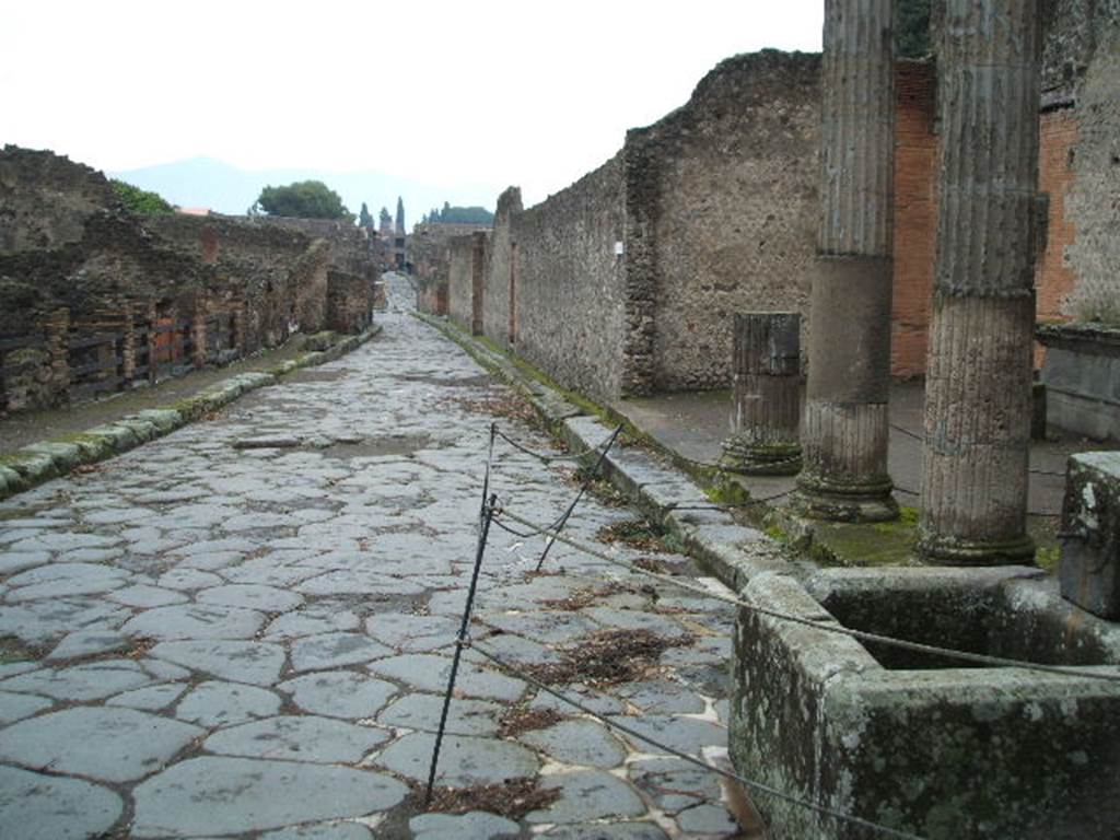 VIII.4 on left. Looking east along Via del Tempio dIside. Fountain and VIII.7.30 on right.