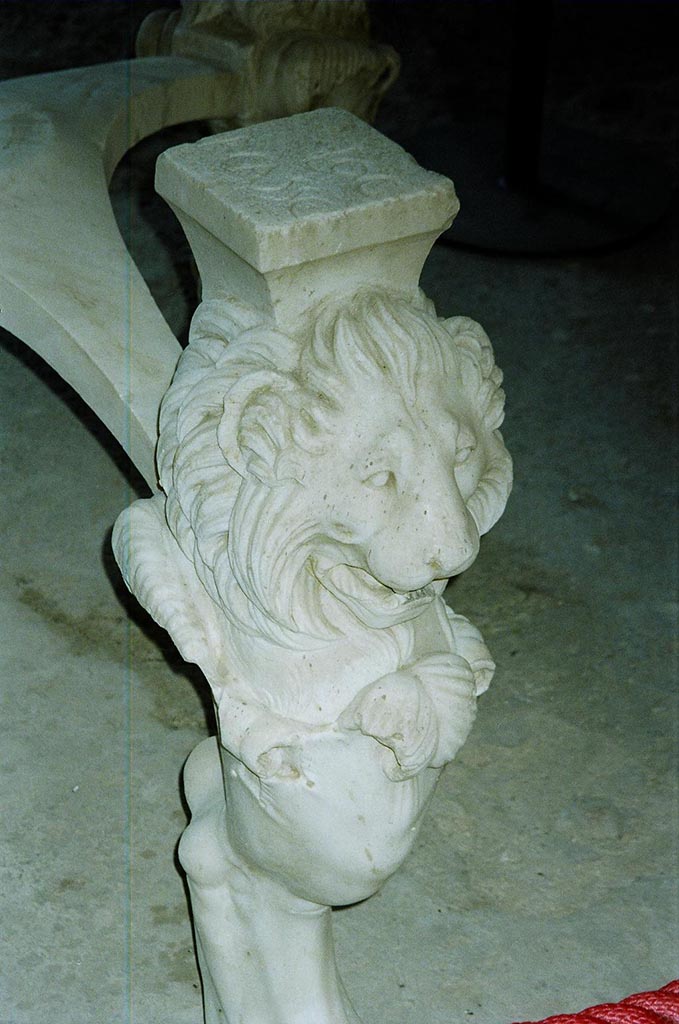 I.6.11 Pompeii. June 2010. 
Lions head on front of the third marble table leg. Photo courtesy of Rick Bauer.
