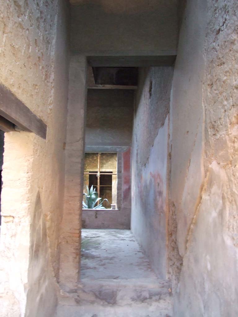I.7.2 Pompeii. December 2007. Stairway to upper floor at front.  
Looking south through site of staircase, through a room that would have been under the stairs, to atrium of I.7.3.
