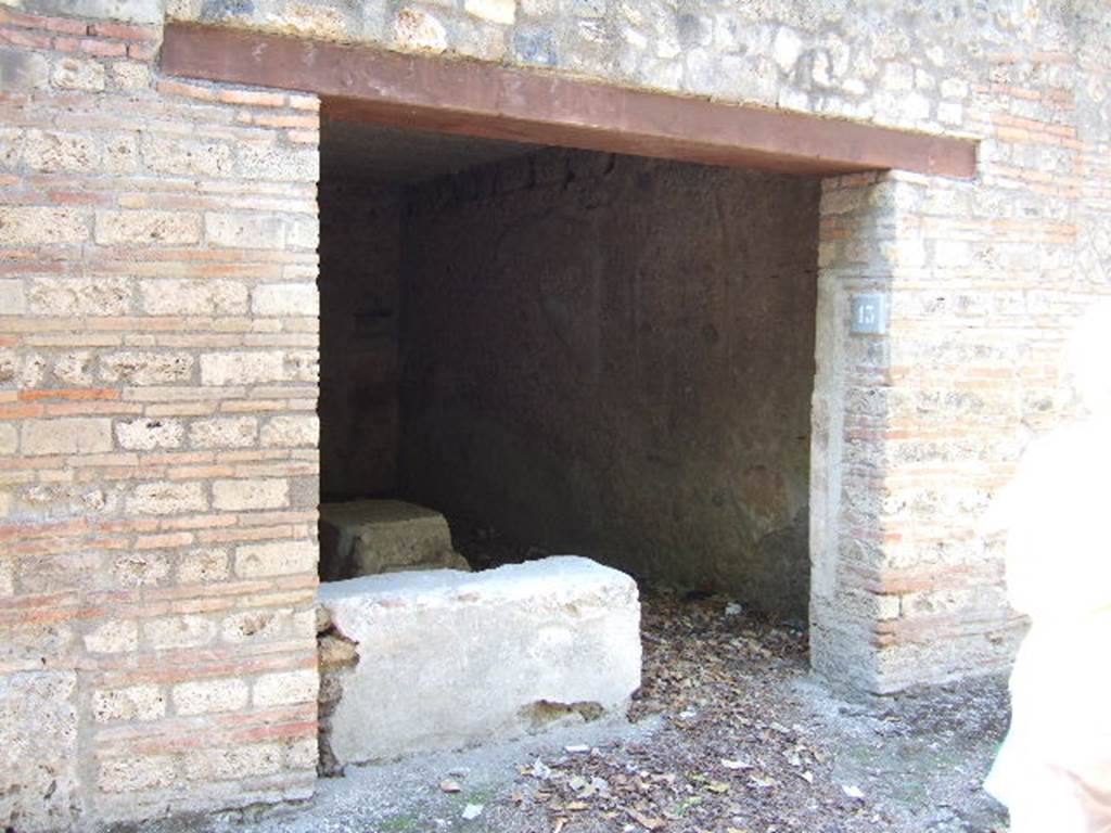 I.10.13 Pompeii. September 2005. Entrance doorway.
According to NdS, -
This wide doorway, with a wooden threshold and brick door-jambs, led into a rectangular room (6.10m x 3.50m) with walls covered by a high cocciopesto zoccolo, and upper walls plastered, the flooring was cocciopesto, and the ceiling was flat. 
In the west wall, other than a bricked-up doorway communicating with one of the rustic rooms of the Casa del Menandro, the first brick steps of a wooden stairs leading up to the mezzanine was found in the south-west corner. 
The threshold was occupied with two thirds of the short side of the brick counter covered in cocciopesto and painted red, having the hearth at the west end of the long side and two small clay dolia embedded into it.
For the finds, found on this counter, see NdS, 1934, p.340.
For details of finds from this house, 
See Allison, P.M. (2006). The Insula of the Menander at Pompeii: Vol. III The finds, Clarendon Press, Oxford, (p.248 & p.367).


