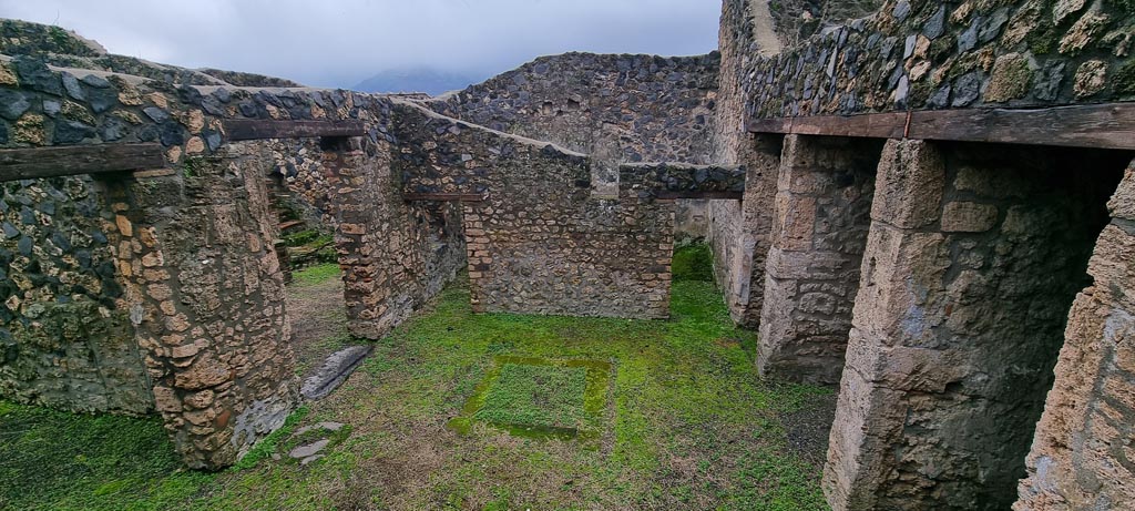 I.11.14 Pompeii. January 2023. 
Looking south across impluvium in atrium, with doorway to small peristyle garden, centre left. Photo courtesy of Miriam Colomer.

