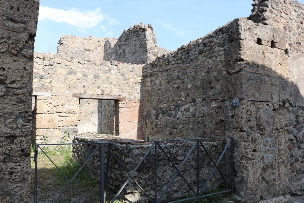 VI.14.36 Pompeii. December 2018. 
Looking south-east to entrance doorway on east side of Vicolo dei Vettii.  Photo courtesy of Aude Durand.
