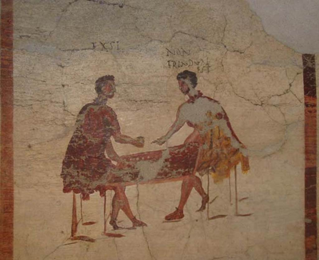 VI.14.35/36 Pompeii. May 2003. Fresco of a scene of gambling, from the north wall. Photo courtesy of Nicolas Monteix. Now in Naples Archaeological Museum.  Inventory number 111482.
According to Berry, a man says “I’ve got it”.  Another man on the right says “Its two not three”.
See Berry, J., 2007. The Complete Pompeii. London, Thames & Hudson, (p.231-2)

According to Epigraphik-Datenbank Clauss/Slaby (See www.manfredclauss.de), these are part of CIL IV 3494;

Exsi(!) non
tria(!) duas(!)
est //        [CIL IV 3494 part]

