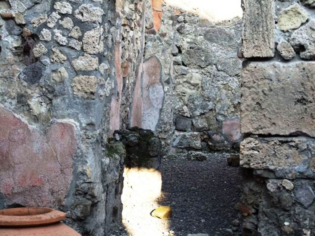 VI.14.36 Pompeii. December 2007. Doorway on north side of the east wall, leading to the kitchen. According to Guzzo, (ed.), “a wooden staircase at the side of the kitchen led to the upper floor. At the moment of the eruption, two people were trying to shelter from the rain of pumice on the upper floor of the building. Maybe the owners or the managers of the bar, and in their flight they had taken their most precious valuables”. See Guzzo, P. (ed). (2003): Tales from an eruption, Pompeii, Herculaneum, Oplontis. Milan: Mondadori Electa, (p. 108)
