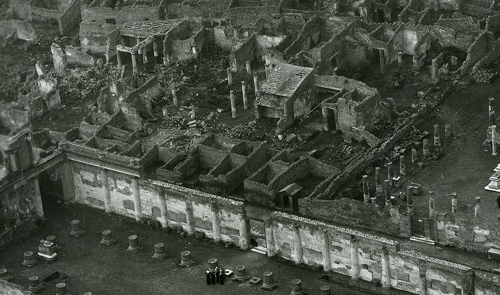 VII.7.5 Pompeii. 1944, detail taken from USAAF aerial photo. Looking north-west across the Basilica and Via Marina, lower left in photo.
On the north side of the Via Marina, in the upper part of the photo, the house of House of Romulus and Remus (VII.7.10), and House of Tryptolemus (VII.7.5 and VII.7.2) can be seen on the west side of the Temple of Apollo, which is on the right. 
Photo courtesy of Rick Bauer. 
