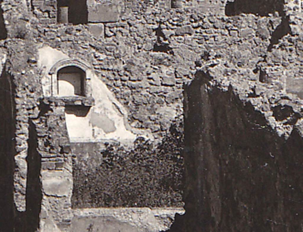 VIII.3.21 Pompeii. Detail of niche and garden from postcard dated 1st August 1939. 
According to Boyce, in the north wall of the garden was an arched niche adorned with an aedicula faade.
The faade had a modelled stucco cornice running around the curve of the arch.
It also had a heavy ledge projecting from the wall.
The inside walls of the niche were covered with white stucco and outlined with red stripes.
See Boyce G. K., 1937. Corpus of the Lararia of Pompeii. Rome: MAAR 14. (p.76, no.356, & Pl.3,5 photo by Warscher).
Photo courtesy of Drew Baker
