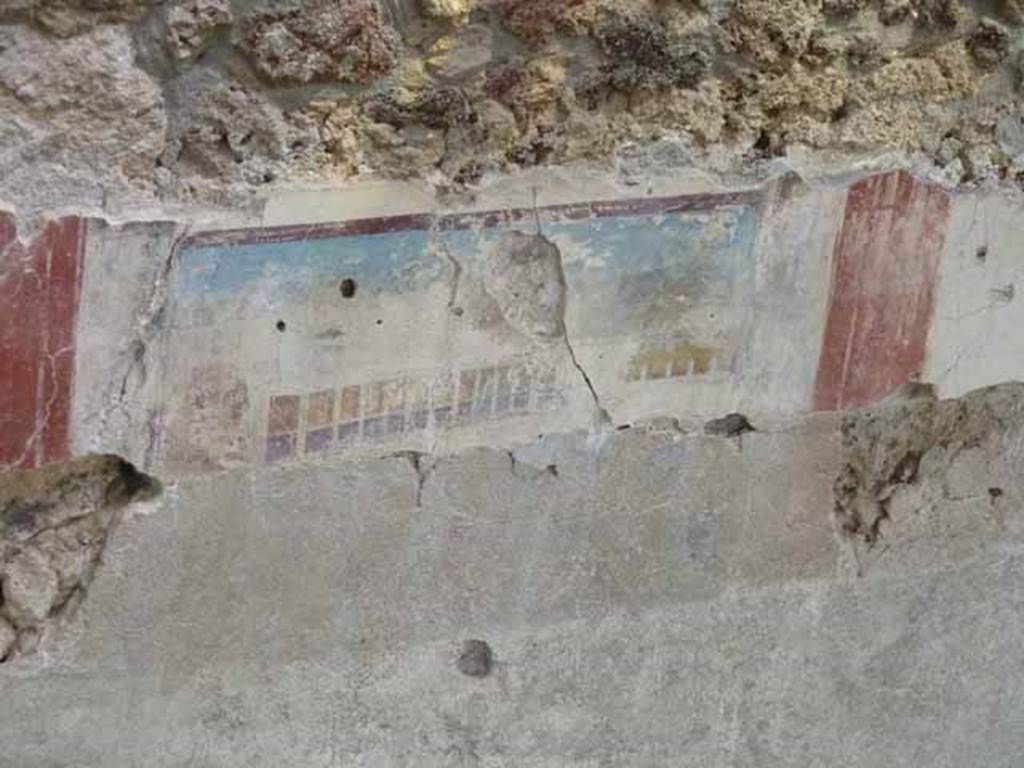 Detail of painted east wall in room being excavated, on west side of bakery at IX.12.6. 