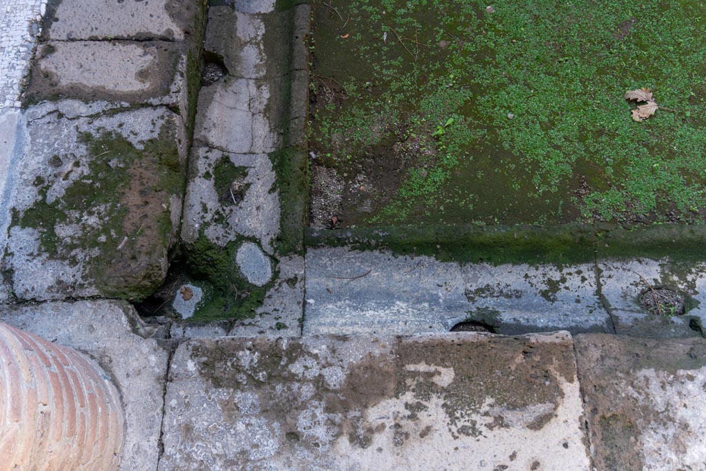 Villa of Mysteries, Pompeii. October 2023. 
Looking towards north-east corner of impluvium, with gutter. Photo courtesy of Johannes Eber.
