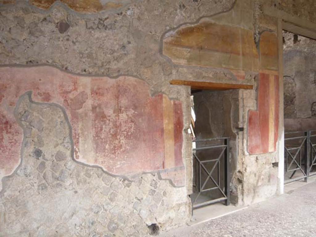 Villa of Mysteries, Pompeii. May 2012. Peristyle C, east wall. The first door on the left is to the unnumbered room next to room 66, on the right. Photo courtesy of Buzz Ferebee.
