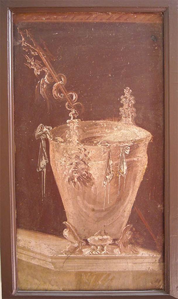 Villa of P. Fannius Synistor at Boscoreale. Peristyle E. Painting of a situla placed on a podium as an athletic winners reward. It has three low feet in the form of feline legs, with a tapered body with a high lip slightly turned. The handles are in the form of Silenus masks.
Outside the bowl hang the ribbons of the winner, while behind it, and placed obliquely a trident with twisted a fantastic animal. Now in Naples Archaeological Museum.  Inventory number s.n. 7. See Sampaolo V. and Bragantini I., Eds, 2009. La Pittura Pompeiana. Electa: Verona. 56b, p. 176.