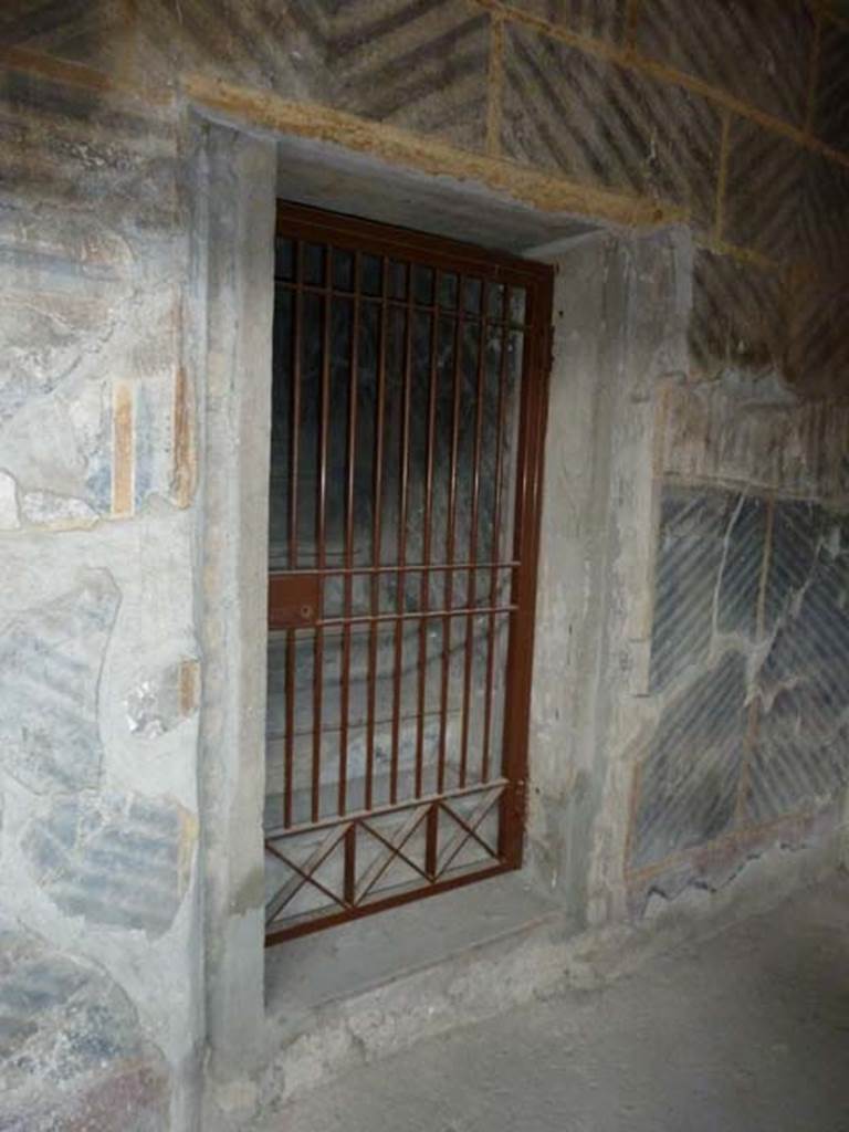 Oplontis, September 2015. Room 32, doorway to room 42, steps to upper floor, on east side of internal peristyle.  Steps leading to a mezzanine floor above rooms 43 and 44. The upper floor would have consisted of three small rooms and a corridor. 

