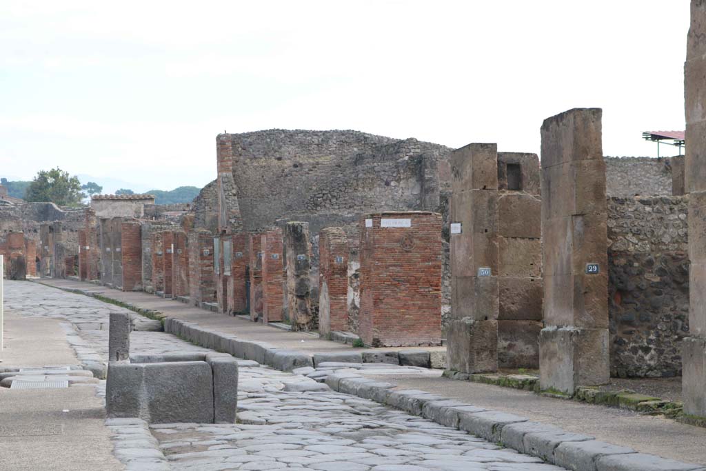 Via dell’Abbondanza, north side. August 2021. 
Looking north towards fountain in front of VII.4.13 and VII.4.14 Pompeii. Photo courtesy of Robert Hanson.


