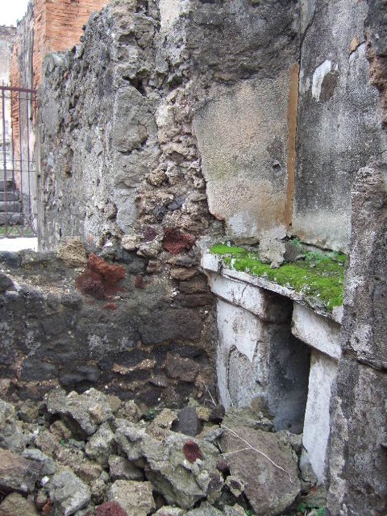 VII.9.47 Pompeii. December 2005. Room 10, sacellum.
According to PPM, a masonry altar was built in a recess against the east wall supported by two massive pillars which were painted in black: 
the middle zone of the wall painted above, was in yellow.
See Pompei: Pitture e Mosaici, Vol. VII  parte 1, Roma: Istituto della enciclopedia italiana, (p.364)

