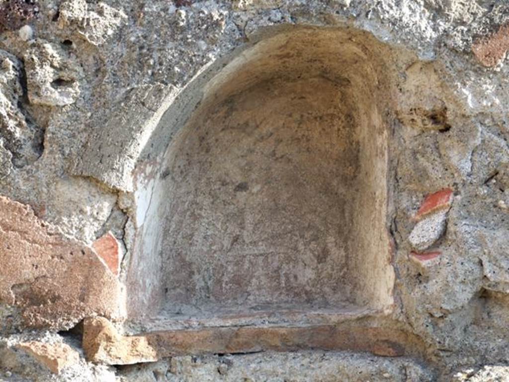 VII.13.7 Pompeii. December 2007. Niche on east wall of dwelling.
According to Boyce – 
in the east wall of the back room, above the hearth, was a small arched niche (h.0.33, w.0.30, d.0.18, h. above hearth 0.20).
See Boyce G. K., 1937. Corpus of the Lararia of Pompeii. Rome: MAAR 14. (p.71, no.324, with Pl.2,5) 

