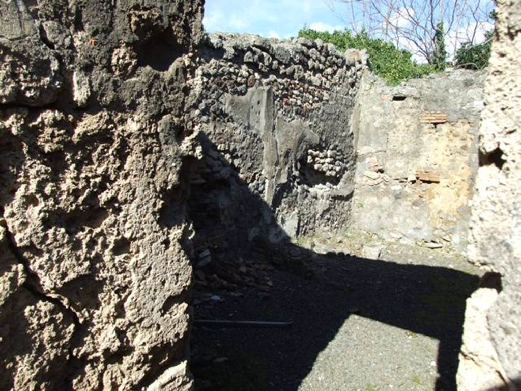 IX.9.12 Pompeii.  March 2009.  Doorway to Room 15, Kitchen. Looking east from Room 16, the Light-yard.