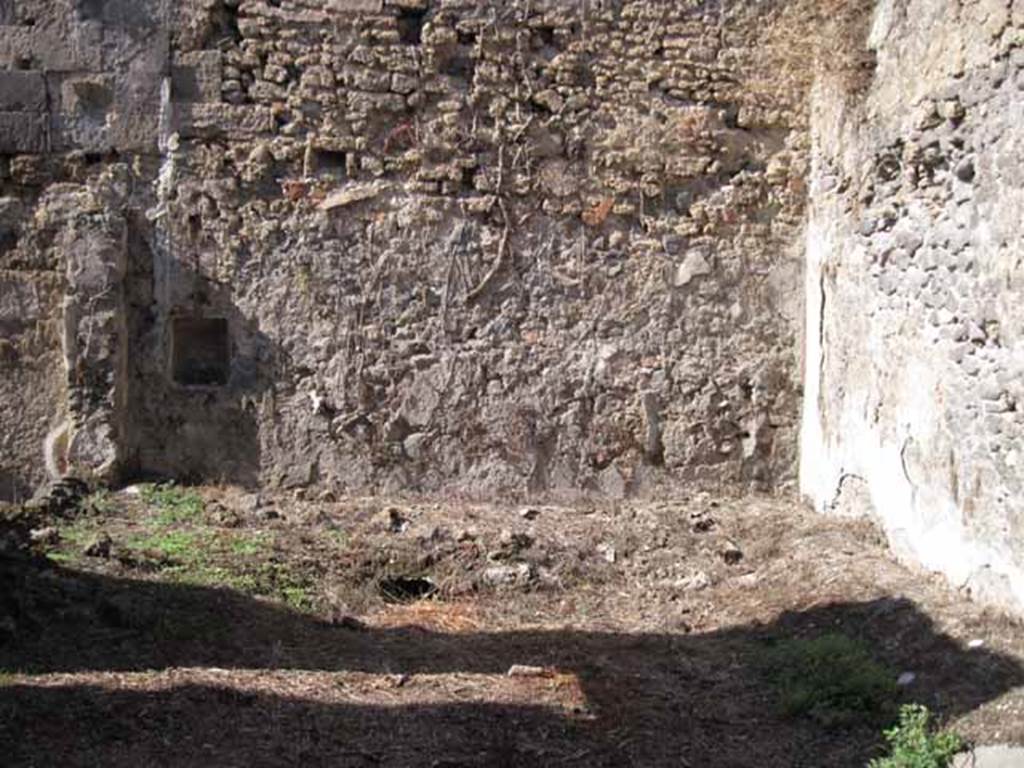 I.2.10 Pompeii. September 2010. Looking north across peristyle area. The peristyle was badly damaged during the bombing in September 1943. The remains of the summer triclinium can be seen against the north wall. In the north wall, on the left, is a square niche. Photo courtesy of Drew Baker.
