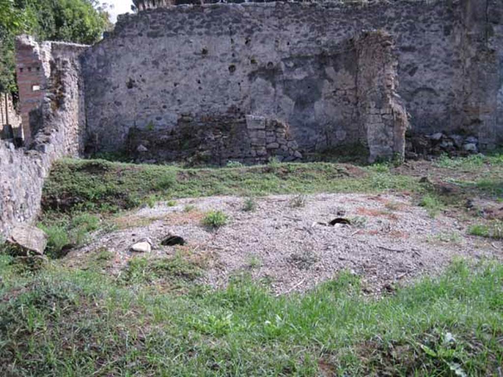 I.2.24 Pompeii. September 2010. 
Looking south across peristyle over remains of the triclinium, towards the three rooms on the south side. 
On the left could be the remains of the altar base.  Photo courtesy of Drew Baker.


