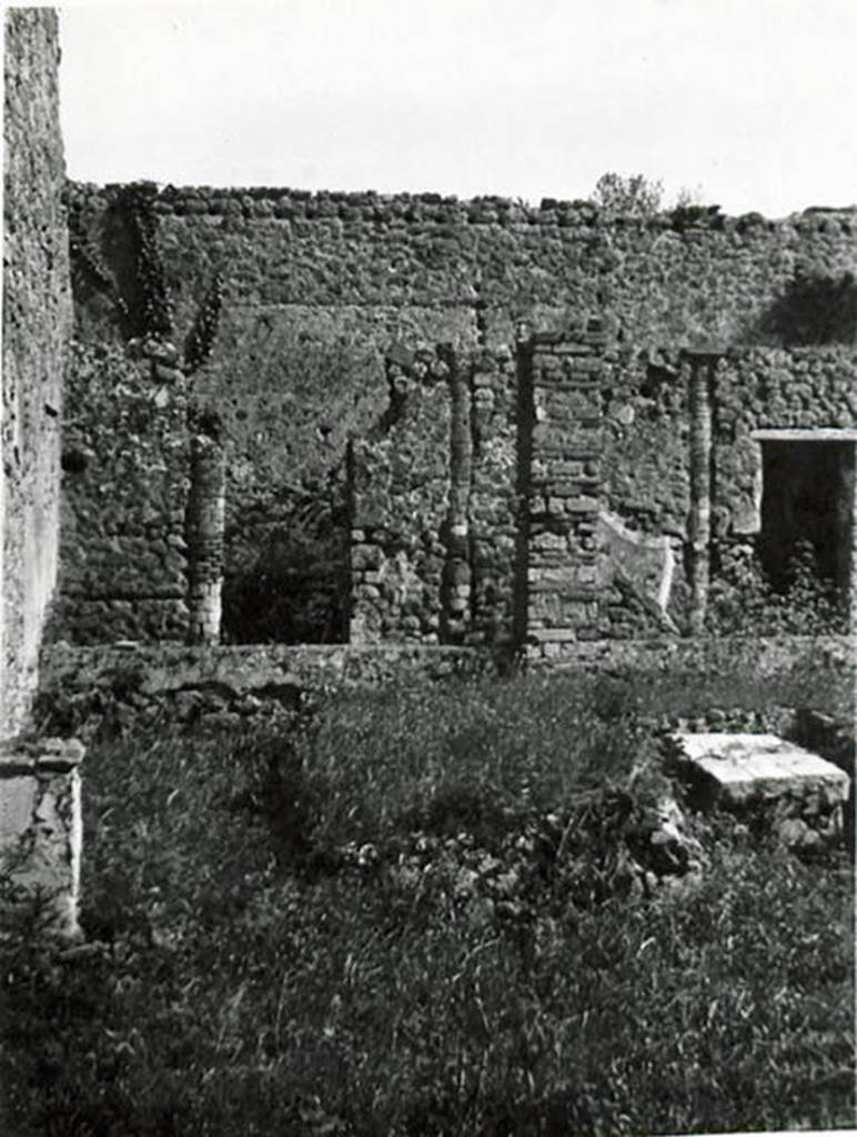 I.2.24 Pompeii. 1935 photo taken by Tatiana Warscher. Looking south across peristyle over remains of the triclinium, towards the rooms on the south side. On the left, the altar base can be seen, (see description from Boyce, on one of the photos above). 
See Warscher T., 1935. Codex Topographicus Pompeianus: Regio I.2. (no. 46), Rome: DAIR, whose copyright it remains.
According to Warscher, quoting Bull. Inst. 1874, p.255-256,  –
I.2.24. “Evidentemente in origine il peristilio aveva 6 colonne di mattoni verso O, e 4 verso S, congiunte da un muricciuolo alto m. 0,52, e coi suoi portici occupava tutta quella parte della casa, dimodochè intorno ad esso non vi erano camere, ad eccezione del triclinio, il quale benchè si apra sul peristilio, sta però piuttosto accanto all’atrio.
Più tardi però, quando si cercò di guadagnar più camere, qui pure, come in tante altre case, il peristilio dovette subire cambiamenti. L’estremità settentrionale, cioè del portico occidentale fu trasformata in una cameretta, nel cui muro orientale è conservata ancora una colonna. Tale cameretta ha la porta verso S ed una finestra verso E sul viridarium; nell’angolo SE di essa un rialzo di materiale mostra l’impressione d’un vaso rotondo.
Inoltre si inchiusero in un muro le colonne meridionali, trasformando quel portico in due camere, di cui la prima (da E serviva di cucina: vi si trova focolare, forno e cesso). 
Per supplire poi al portico così perduto, fra la penultima, adesso ultima, delle colonne occidentali e il muro orientale si costruì un pilastro quadrato: una trave, che congiunse colonna, pilastro e mura, dovette sorreggere il tetto dalla parte del viridario trasformata così in un portico. Più tardi soltanto quel pilastro fu congiunto col muro e colla colonna da un muricciuolo come quello del lato occidentale. - Tutti questi cambiamenti si riconoscono in modo indubitabile: I muri delle camere verso S sono appoggiati soltanto al muro meridionale, non congiunti con esso, e la stessa decorazione del peristilio continua nelle camere. Altri cambiamenti, che però ne’dettagli non è possibile di rintracciare, ci vengono accennati da una porta murata che all’estremità verso E del portico meridionale congiungeva una volta questo peristilio colla casa adiacente. - Presso l’angolo SO, accanto alle camere meridionali, una parte del suolo è innalzata un poco e inchiusa a linea curva verso E da un muricciuolo (alto m. 0,61 di fuori, 0,52 di dentro), del resto da un margine poco elevato; e chiara ne è la destinazione: vi si trovarono alcune anfore, appoggiate al muro. - Sul lato meridionale del pilastro summentovato troviamo la seguente iscrizione, la cui significazione sarà simile a quella dell’iscrizione de’librari; siccome però è scritta a carbone, così  non sene poteva leggere che questo:

Q  VERANIVS  RVFVS   C   POMIO  IIVS  CALVS
VEDIVS  SIRICVS           C             SANT       III
      RENTIVS FELIC                                                         (CIL IV. 3952)
(translation: I.2.24 “Evidently the original peristyle would have had 6 masonry columns towards the west side,  and 4 towards the south, joined by a wall 0,52m high, and with its porticoes covering all that part of the house, so around it there were no rooms, with the exception of the triclinium, which although it opened onto the peristyle, it was however rather near to the atrium. Later though, when more rooms were sought, as in many other cases, the peristyle underwent changes. The northern end of the western portico was altered into a room, in the east wall of which, a column was still preserved. This room had a door towards the south and a window towards the east onto the garden: in the south-east corner a prominence of material showed the impression of a round pot. Also enclosed into a wall were the southern columns, transforming this portico into two rooms, of which the first (from the east, used as a kitchen: hearth, oven and latrine).To compensate for the lost portico, a square pillar was built between the penultimate and last western columns and the eastern wall; a