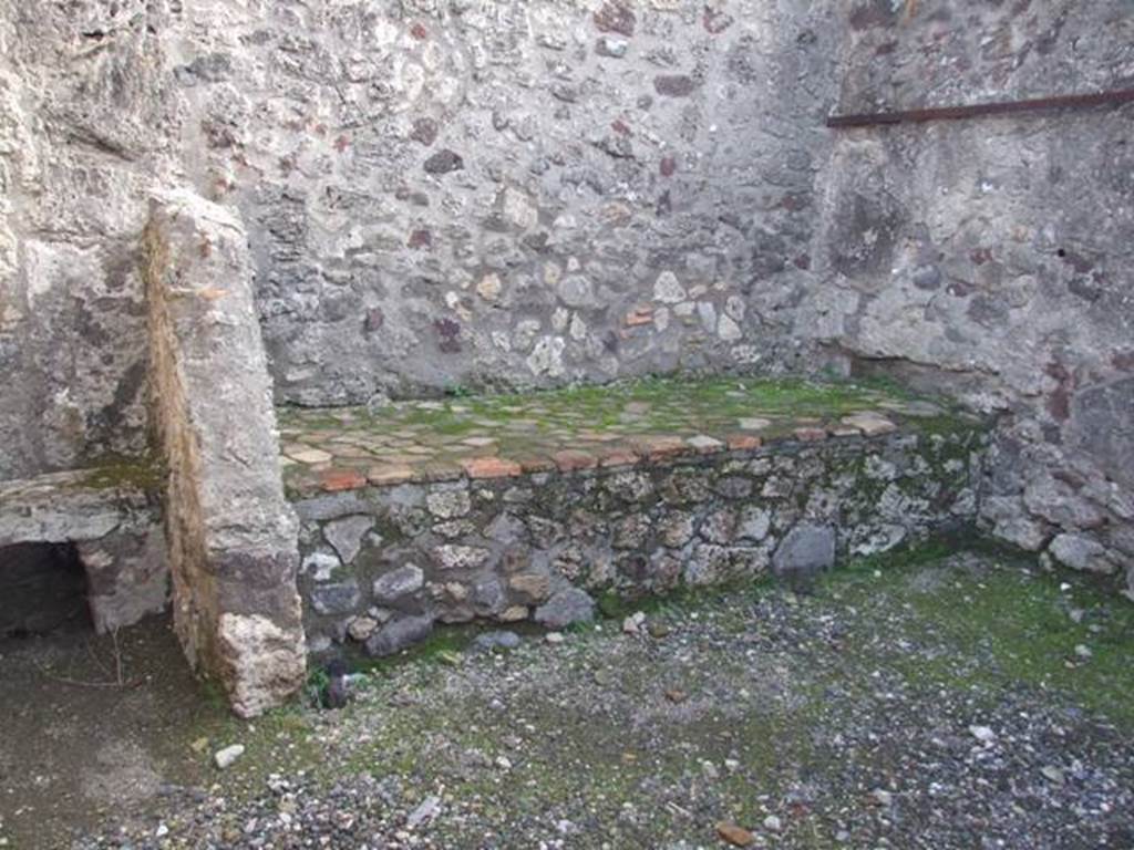 VI.1.10 Pompeii. December 2007. Room 11, east wall with latrine and hearth,and south-east corner of kitchen.  According to Boyce, the print in Piranesi showed the south wall of the kitchen covered with a lararium painting in two zones.  In the upper zone was the figure of the Genius, pouring a libation on an altar, to the right of him stood a small Camillus.
On each side of this central group was an indistinct figure.  Above this zone are two other indistinct figures.  In the lower zone were the two serpents confronted at an altar.  See Boyce G. K., 1937. Corpus of the Lararia of Pompeii. Rome: MAAR 14. (p.43, no.135) 
According to Giacobello, in the south corner of the kitchen a lararium painting was found upon excavation, but in a bad condition.  It is no longer conserved, but drawn by Piranesi.  Nissen referred to the existence of a niche near the hearth, no longer visible by Boyce’s time.
See Giacobello, F., 2008. Larari Pompeiani: Iconografia e culto dei Lari in ambito domestico.  Milano: LED Edizioni. (p.171)
See Fröhlich, T., 1991. Lararien und Fassadenbilder in den Vesuvstädten. Mainz: von Zabern. (L56, picture 37,2)
According to Boyce, Nissen referred to a niche for the Lares in one of the rooms in the neighbourhood of the kitchen.  Nissen, 410
See Boyce G. K., 1937. Corpus of the Lararia of Pompeii. Rome: MAAR 14. (p.43, no.136) 
