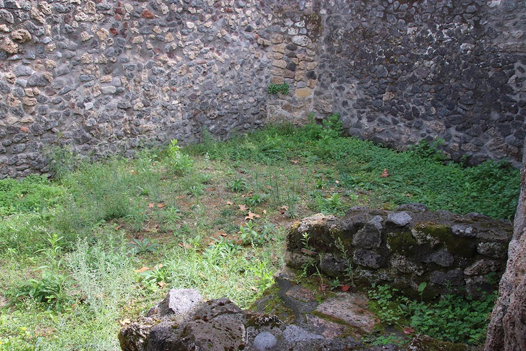 I.1.2 Pompeii, October 2024. Room “c”, looking across hearth against west wall, towards south-east corner. Photo courtesy of Klaus Heese.