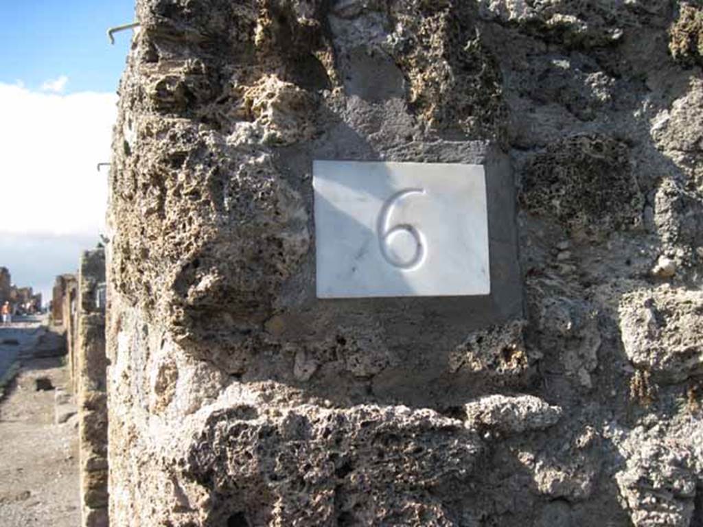 1.2.6 Pompeii. September 2010. ID number plate, and looking north along east side of Via Stabiana, from entrance. Photo courtesy of Drew Baker.
