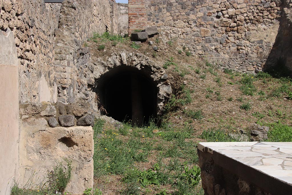 I.2.13 Pompeii. October 2024. North-east corner of bar-room, lower front.
Looking east towards site of small storeroom or cupboard, bombed in 1943, centre of photo. Photo courtesy of Klaus Heese.
