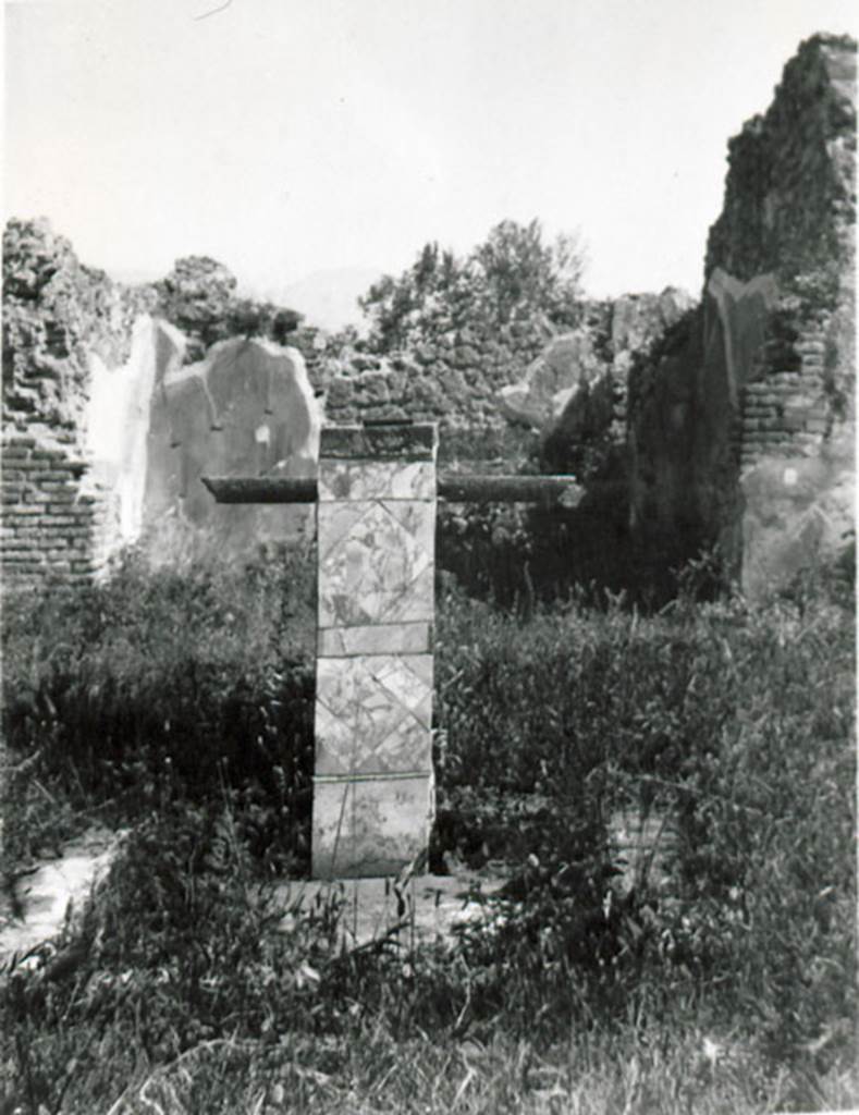 I.2.17 Pompeii. 1935 photograph taken by Tatiana Warscher. 
Looking south across atrium towards base and impluvium.
According to Warscher, quoting Bull. Inst, 1874, p.264 –
I.2.17 “Nell’ atrio dietro l’impluvio di marmo sta un base, nella parte anteriore rivestita di marmo, e dietro di essa una tavola sopra sostegno quadrangolare.
La decorazione dell’atrio è semplice: sopra zoccolo nero scompartimenti neri, rossi e gialli. 
A destra dell’entrata abbiamo una camera rozzamente decorata con finestra sul vico.
A sinistra primo un vano, che, come pare, conteneva la scala di legno, sotto la quale un armadio era accessibile dalle fauces, poi la cucina col cesso.
Sul lato destro dell’atrio non v’è nulla, su quel sinistro due camere, congiunte fra loro, la seconda con larga apertura sul peristilio.
Sul lato di fonde vi è il tablino, decorato nello stile della suddescritta stanza del ratto del Palladio (vedi p.199s.) colla pittura d’Endimione, descritta Bull. 1873, p.238.
Dietro il tablino, ma più a sinistra ed accessibile per una porta in fondo ad esso, troviamo un piccolo viridarium, le cui pareti nella parte più bassa hanno dipinto un cancello, sopra delle piante. 
Appoggiata al muro destro vi è una vasca murata, alta m.0,58 dentro e 0,73 fuori, e un’altra accanto a questa prima verso S.
See Warscher T., 1935. Codex Topographicus Pompeianus: Regio I.2. (no.29), Rome: DAIR, whose copyright it remains.
(translation: 
I. 2.17 "In the atrium behind the marble impluvium was a base, in the front part covered in marble, and behind it a table above a four-sided support. The decoration of the atrium was simple: above a black zoccolo were compartments of blacks, reds and yellows.  
To the right of the entrance there is a rough room decorated with a window onto the roadway.  To the left, first one room, which, as it seemed, contained the wooden staircase, under which a cupboard was accessible from the fauces, then the kitchen with toilet.  On the right side of the Atrium there was nothing, on the left side two rooms, joined between them, the second with wide opening onto the peristyle. At the rear side there was the tablinum, decorated in the style of the described room of the painting of the Palladium (see I.2.6), with a painting of Endymion, described Bull. 1873, p. 238. 
Behind the tablinum, but more to the left and accessible by a door at the back of it, we find a small viridarium, whose walls at the lowest part had paintings of a gate, with plants above. Leaning against the right wall there was a walled basin, alta m. 0.58 inside and 0.73 outside, and another next to this first towards the south.")

