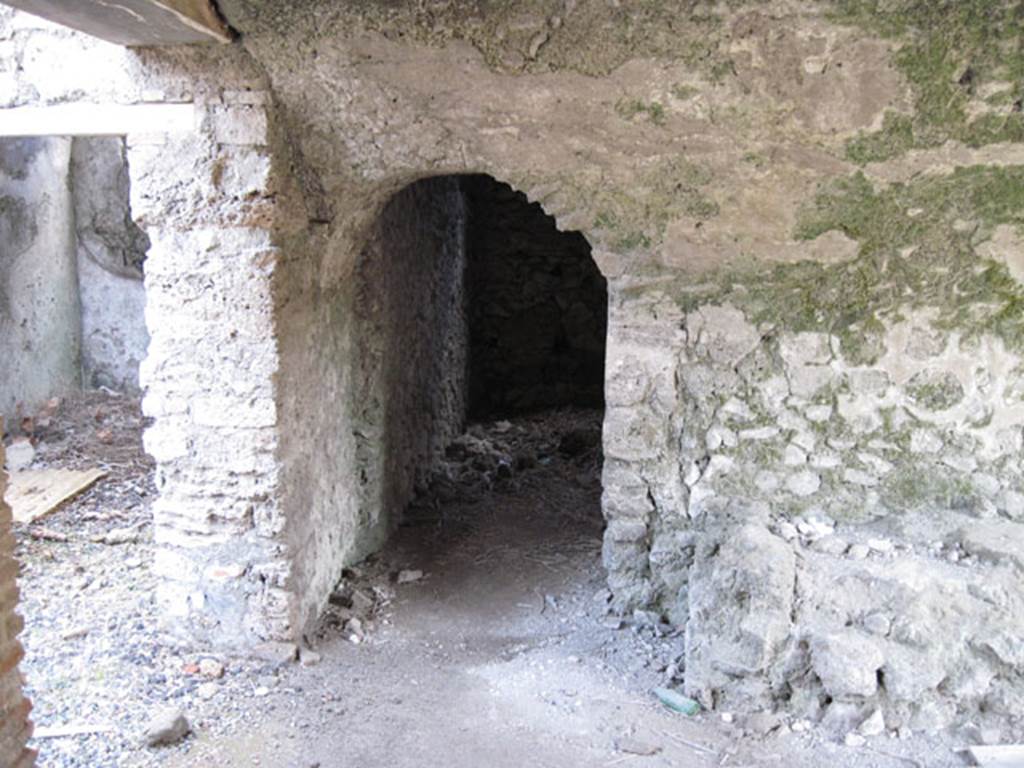 I.3.3 Pompeii. September 2010. Looking east in kitchen towards north-east corner and doorway through to two storerooms, that Fiorelli thought had originally been one large one.
On the left is the doorway towards the wider corridor. Photo courtesy of Drew Baker.
