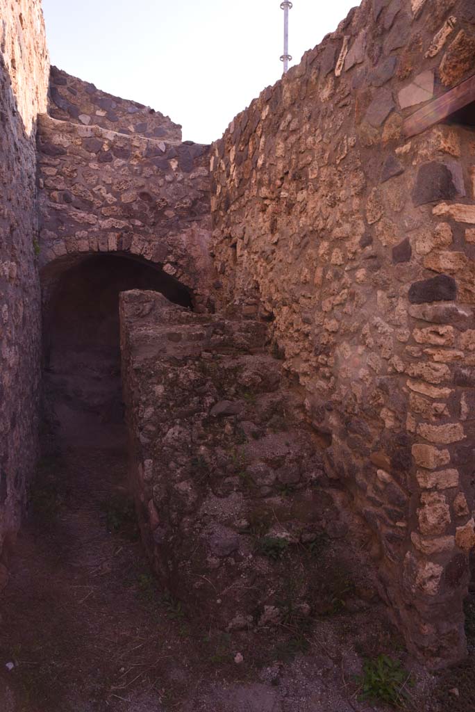 I.4.25/I.4.5 Pompeii. October 2019.  
Unnumbered corridor/room, looking east along south wall, with steps to upper floor.
Foto Tobias Busen, ERC Grant 681269 DCOR.
