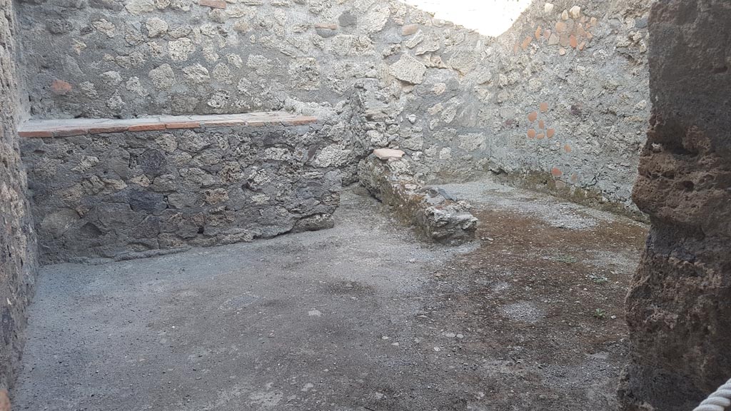 I.6.4 Pompeii. October 2022. Room 8, looking east through doorway towards hearth/bench. Photo courtesy of Klaus Heese. 