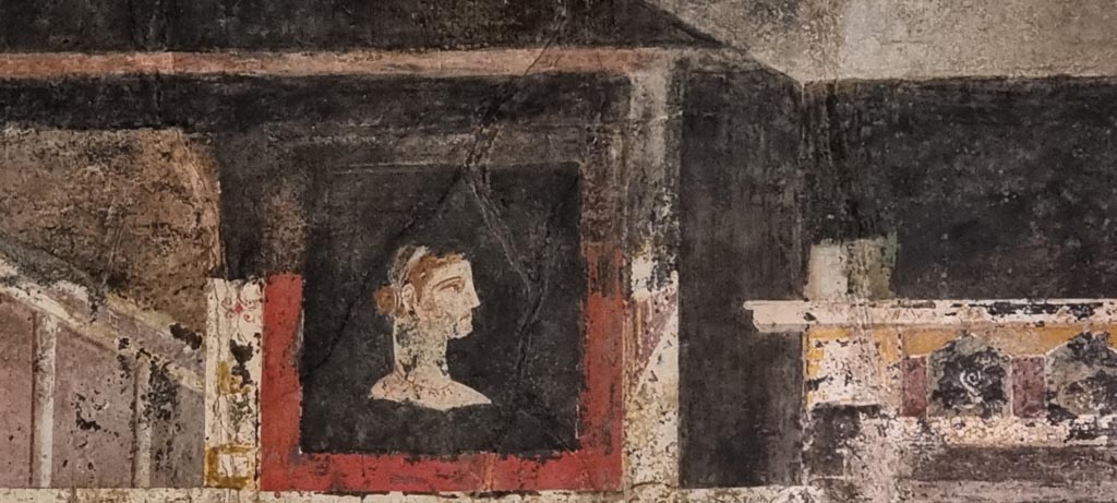 I.9.5 Pompeii. December 2023. Room 10, triclinium, detail from upper west end of north wall. Photo courtesy of Miriam Colomer.