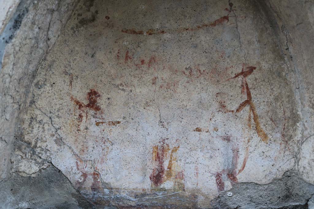 I.10.3 Pompeii. December 2018. 
Painted figures, altar and garland, visible on niche on east wall of fauces. Photo courtesy of Aude Durand.
