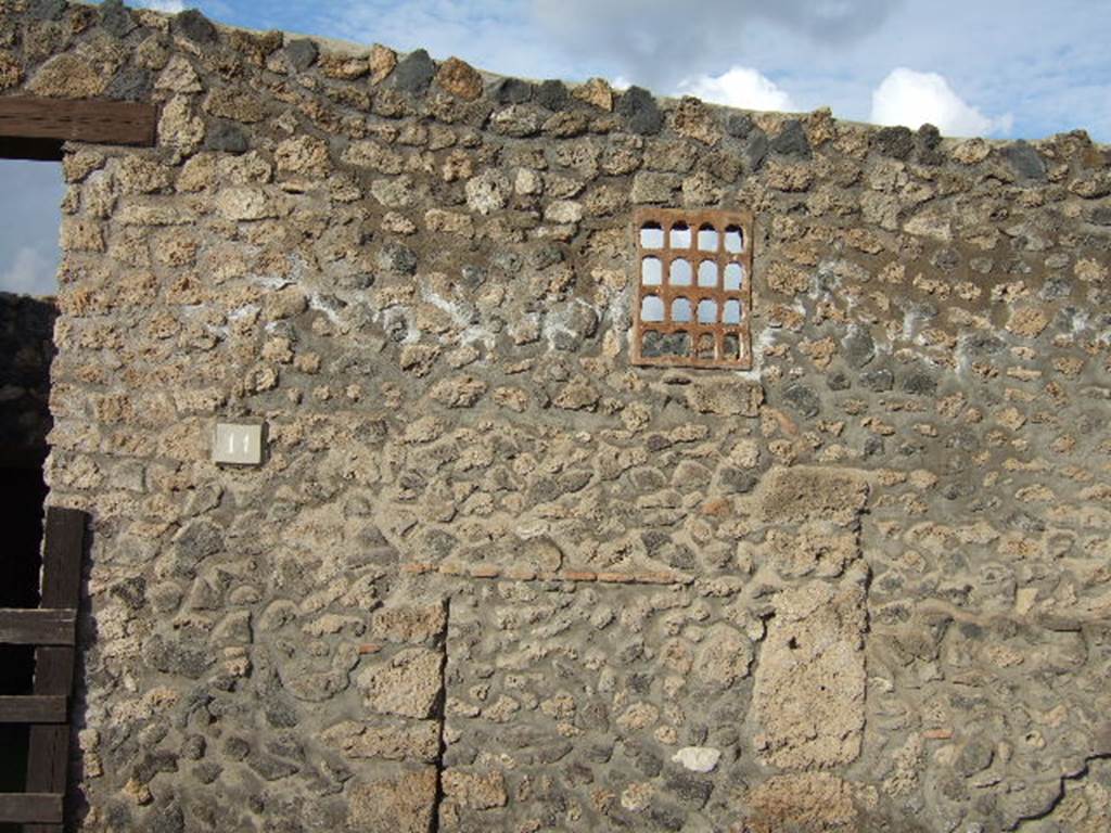 I.14.11 Pompeii. December 2005.  Window on east side of entrance doorway. According to Eschebach this is a terracotta window.
See Eschebach, L., 1993. Gebäudeverzeichnis und Stadtplan der antiken Stadt Pompeji. Köln: Böhlau. (p.71)
  