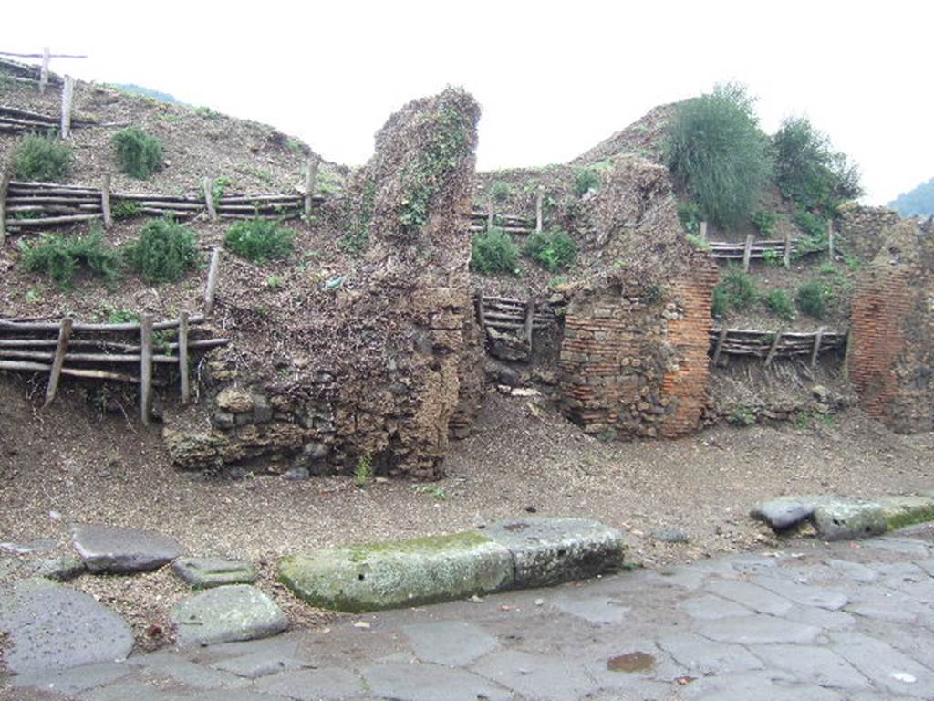 Pompeii. December 2005. III.7.3 with ramp, on left, III.7.4 in centre, III.7.5 on right. Entrance doorways.