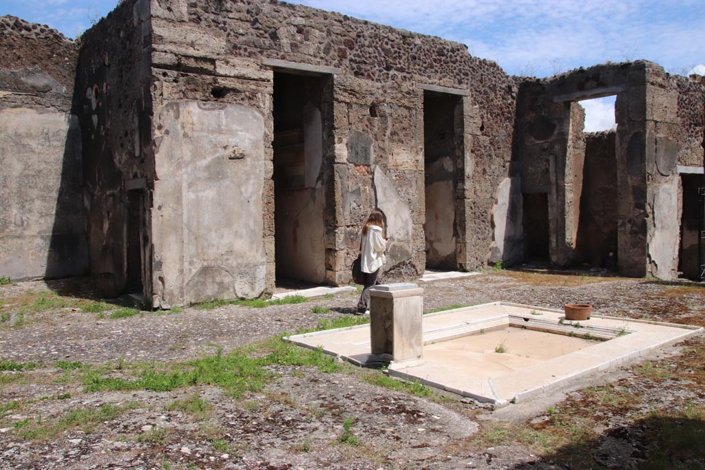 V.1.7 Pompeii. May 2024. 
Looking south-east across impluvium towards rooms 9, 8, 7, 6 and 5, on east side of atrium. Photo courtesy of Klaus Heese. 
