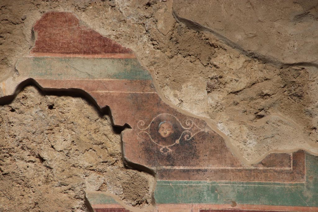 V.2.i Pompeii.  October 2023. 
Room 1, upper east wall on south side of doorway to room 4, detail of fragment of painted panel. Photo courtesy of Klaus Heese.
