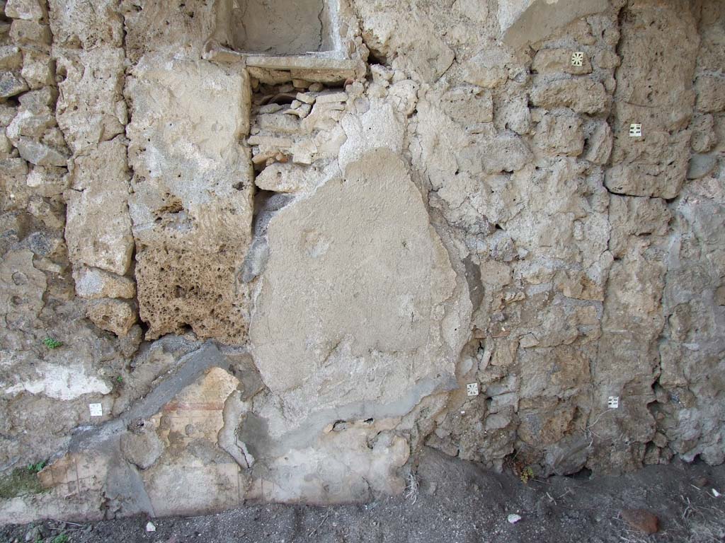 V.4.3 Pompeii. March 2009. West wall of atrium, remains of plaster under the aedicula lararium.  