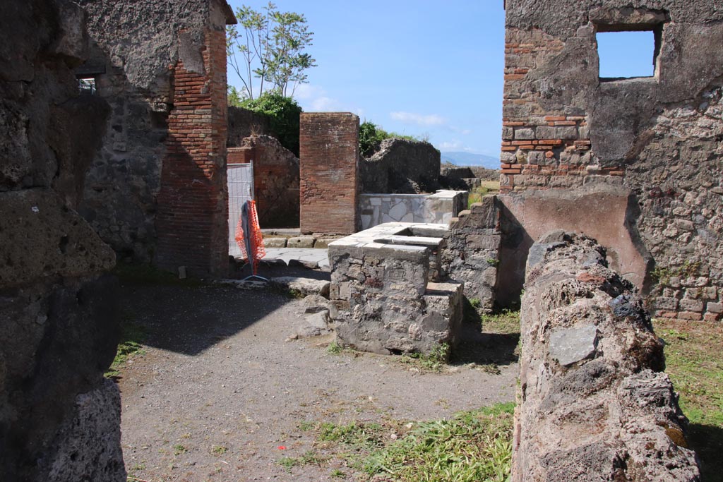 VI.1.5 Pompeii. May 2024. 
Looking west along north side towards counter and entrance doorway. Photo courtesy of Klaus Heese.
