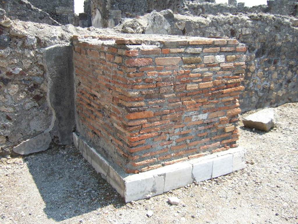VI.1.13 Pompeii. May 2006. East wall. Remains of marble clad pedestal. Statue base?