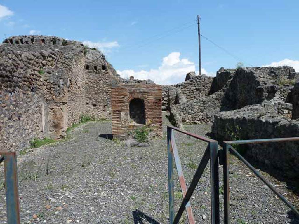 VI.3.10 Pompeii. May 2010. Looking east across workshop, towards rear room, lararium? and passageway to rear.