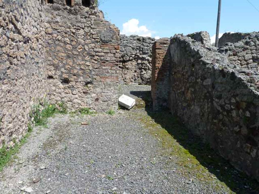 VI.3.10 Pompeii. May 2010. Looking east across rear room on north side of workshop, with doorway to yard at rear.
