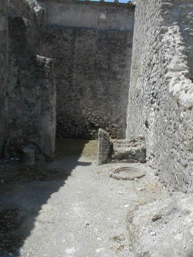 VI.16.5 Pompeii. May 2005. Looking west across shop towards rear room.