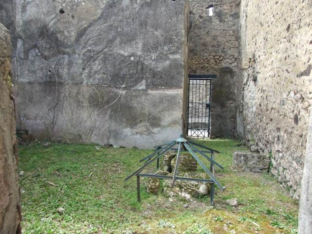 VI.16.29 Pompeii. March 2009. Room O, looking west across to fauces P of entrance VI.16.30. According to NdS, room O was quite spacious and had a rough cocciopesto floor and bare walls, with the usual brick plinth. On the north wall was the base  stone of a wooden staircase. In the north-east corner was the cistern mouth. On the extreme right of the west wall was painted on the plinth, from the right to the left, a serpent agatodemone, which approached towards an altar through plants. Found in the soil of this house on the 29th August 1904, but without a precise indication of place, was the upper part of an altar of red marble (m.0.08 x 0.065). See Notizie degli Scavi di Antichit, 1908, (p.284). According to Boyce, in the room entered from the posticum of VI.16.30 was a lararium. It was on the white ground of the dado of the west wall. A single yellow serpent was painted, advancing to the left towards an altar furnished with offerings. In the background were plants. See Notizie degli Scavi di Antichit, 1908, (p.284). See Boyce G. K., 1937. Corpus of the Lararia of Pompeii. Rome: MAAR 14. (p. 59, no 227).
.