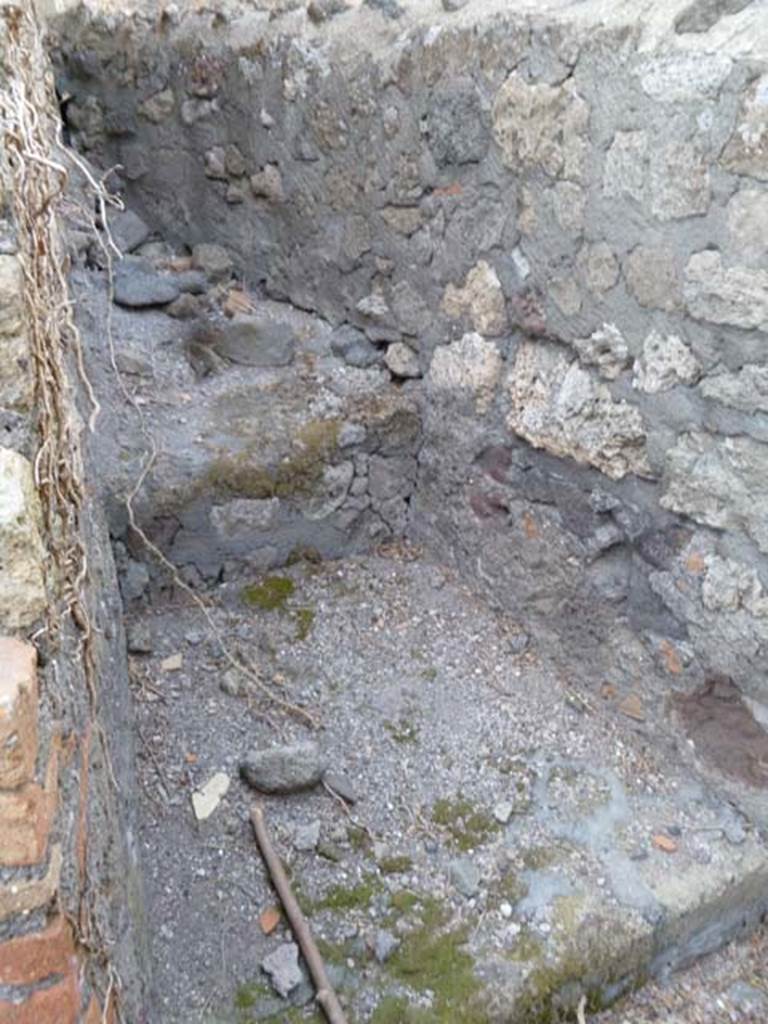 VI.17.1 Pompeii. May 2011. Looking north-east into small room, latrine or corridor on north side of hearth.
