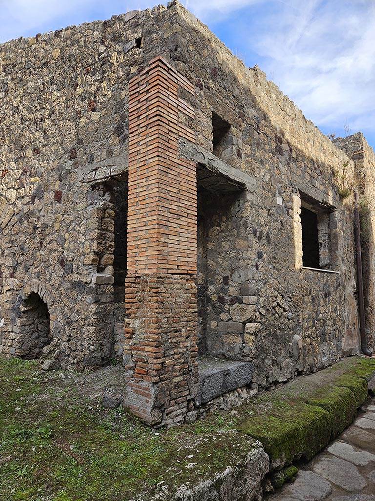 VII.3.26 Pompeii. November 2024. 
Looking east from VII.3.28 along front façade, with doorway to steps at VII.3.27, and window at VII.3.26.
Photo courtesy of Annette Haug.
