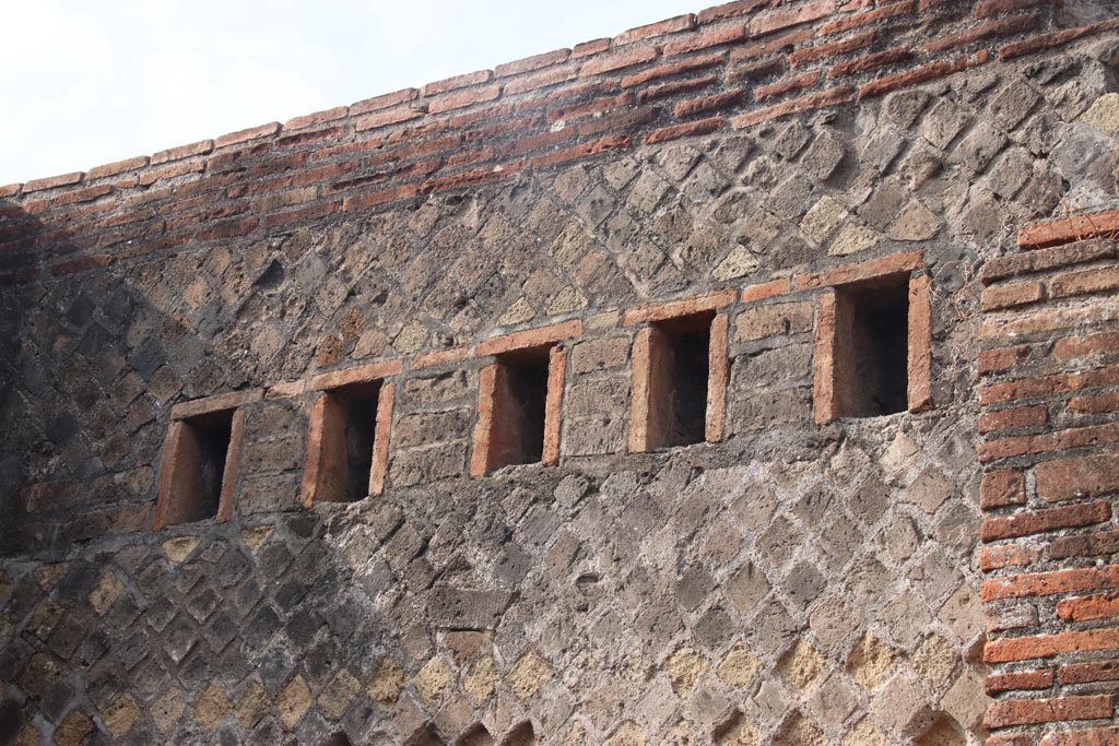 VIII.2.31 Pompeii. October 2023. West wall, detail of holes for support beams for an upper floor. Photo courtesy of Klaus Heese.