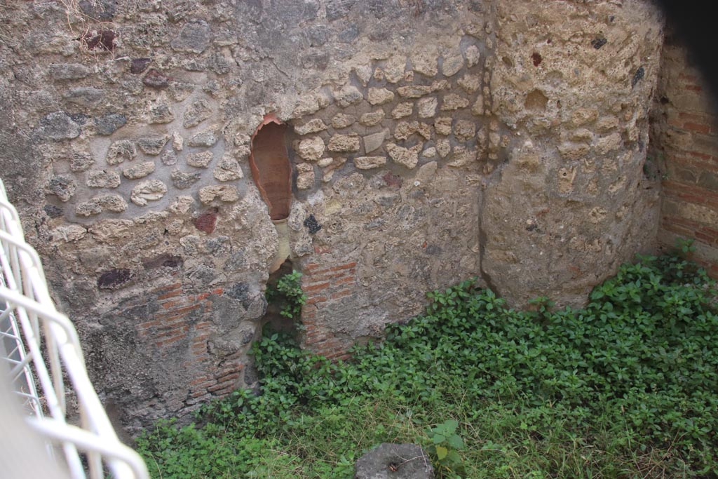 VIII.2.38 Pompeii. October 2023. East wall of shop-room with down-pipe. Photo courtesy of Klaus Heese.