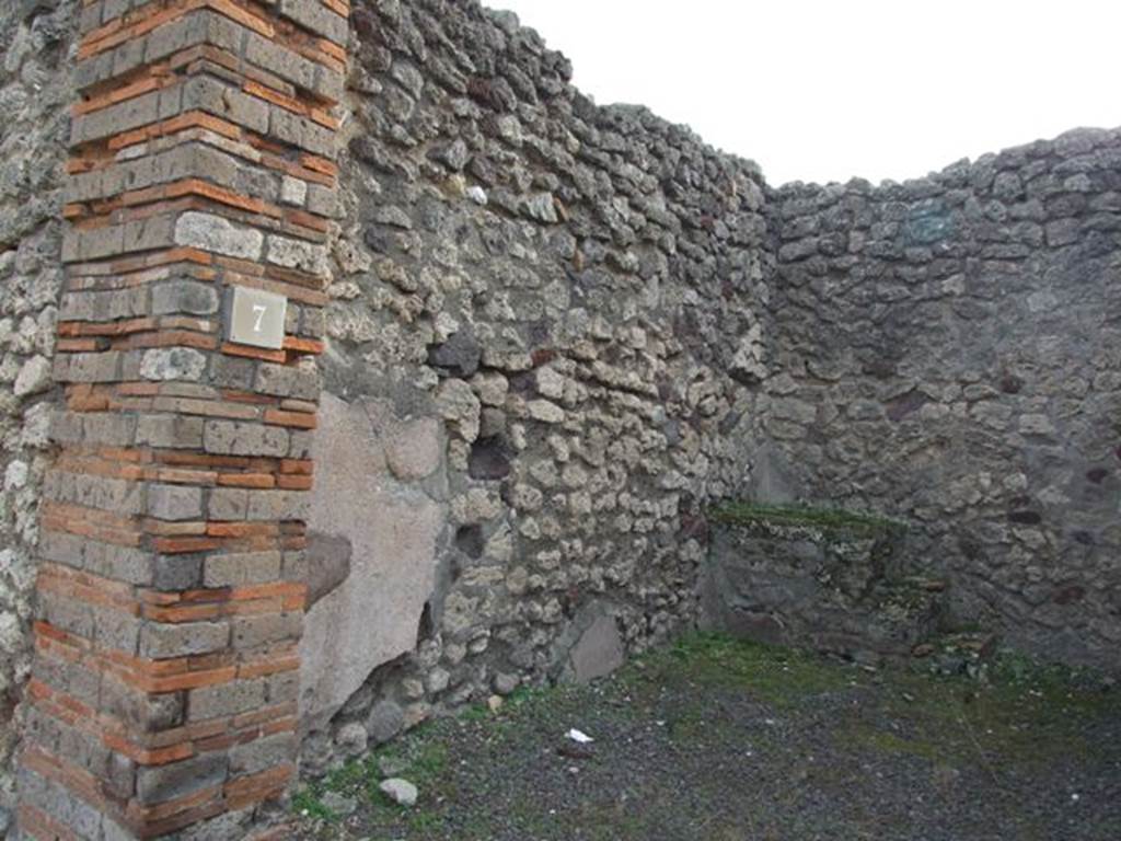 IX.5.7 Pompeii. December 2007. South wall of shop. In the south-east corner, at the rear on the left side, can be seen the base of the three steps to the upper floor.
